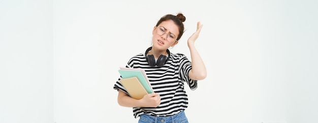 Free photo image of upset young woman student in glasses complains at difficult task at university holding