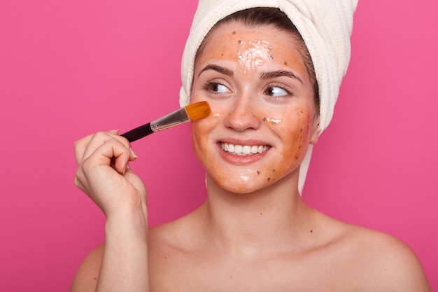 Free photo image of woman holding brush for applying cream