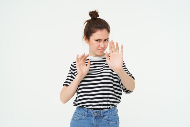 Free photo image of woman refusing something raising hands in defensive gesture protecting herself rejecting