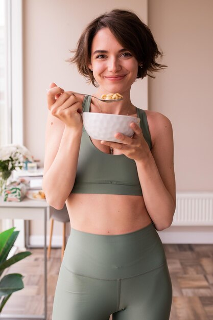 Image of woman smiling and staying with plate of food