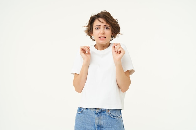 Free photo image of woman with scared face looks frightened worried trembling from fear isolated against white