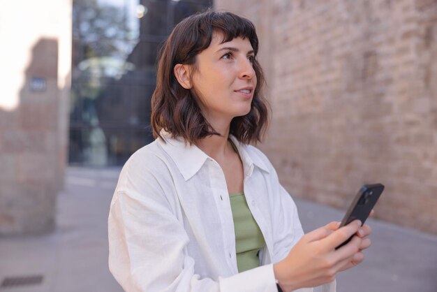 Image of young woman holding smartphone