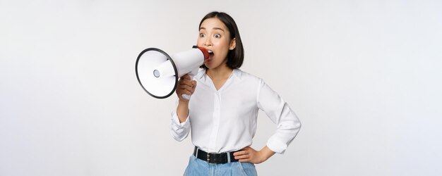 Image of young woman korean activist recruiter screaming in megaphone searching shouting at loudspea