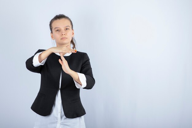 Image of young woman standing and posing on white background. High quality photo