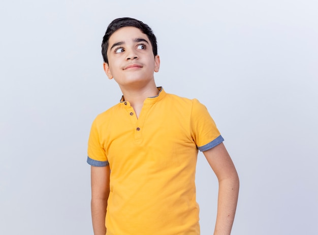 Free photo impressed young caucasian boy looking at side isolated on white background with copy space