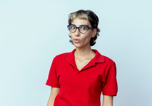 Impressed young caucasian girl with pixie haircut wearing glasses isolated on white background with copy space