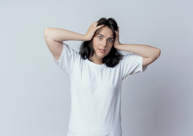 Impressed young pretty caucasian girl holding head looking at camera isolated on white background