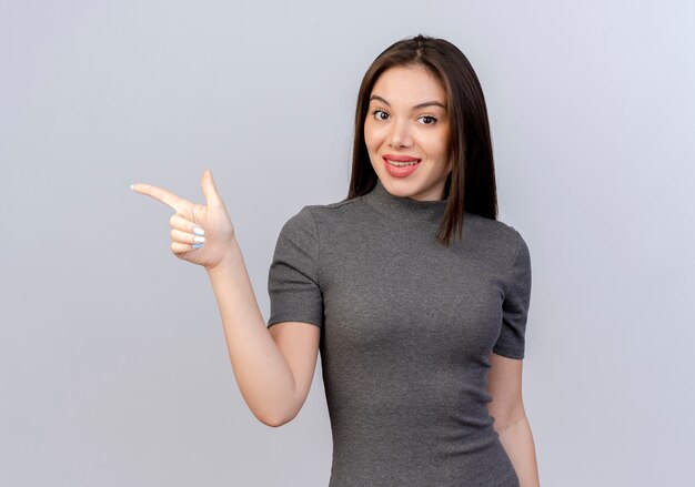 Impressed young pretty woman pointing at side isolated on white background