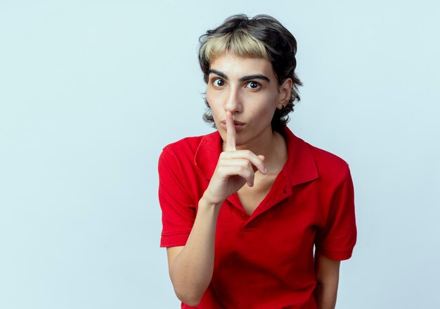 impressed young woman with pixie haircut gesturing silence