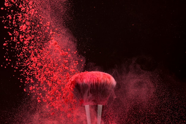 Free photo impressive bright color brush and falling powder