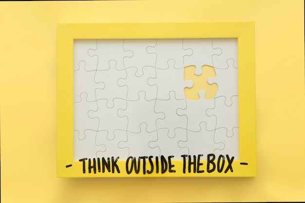 Incomplete jigsaw puzzle frame with think outside the box message