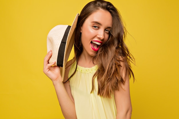 Incredible long-haired woman dressed bright summer dress posing with expressive emotions