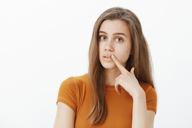 Indecisive attractive girl looking throughful, making decision, thinking about choices