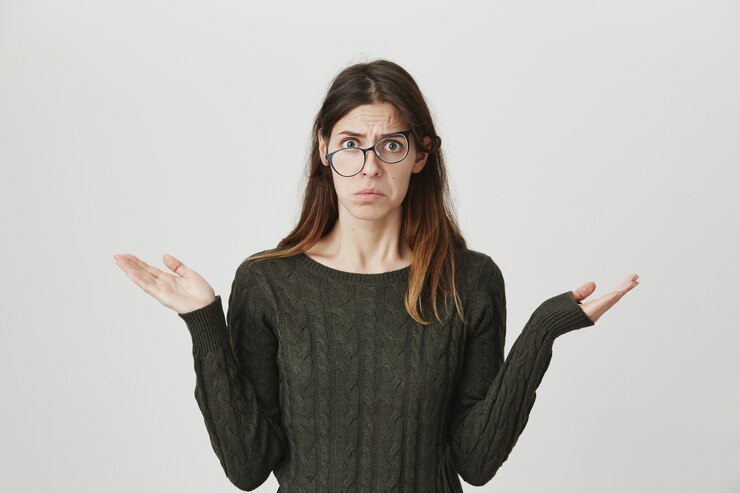Free Photo indecisive perplexed young woman shrugging, don't know, have no idea