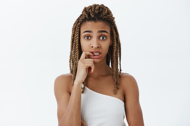 Indecisive and puzzled african-american female student looking confused or unsure