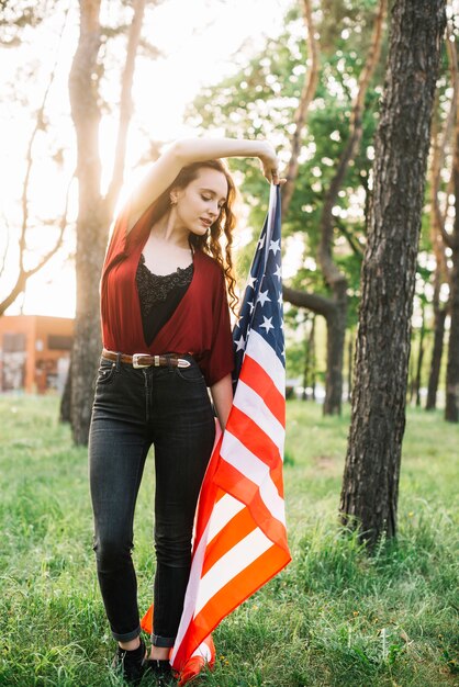 Independence day concept with girl in forest with flag