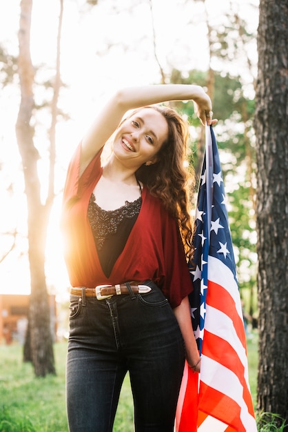 Independence day concept with smiling girl in forest