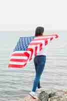 Free photo independence day concept with woman at the sea