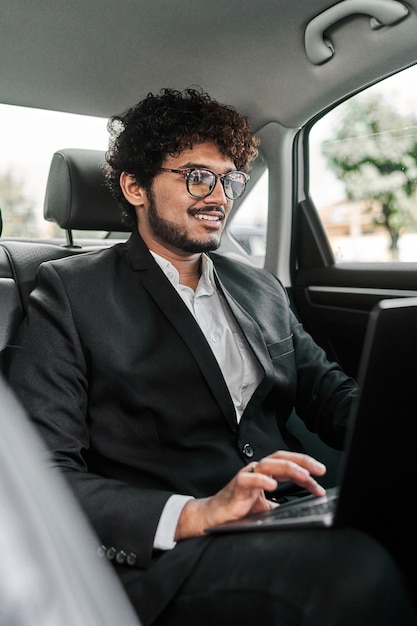 Indian businessman in the backseat.