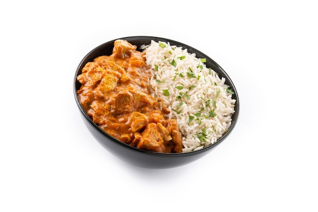 Indian butter chicken in black bowl isolated on white background