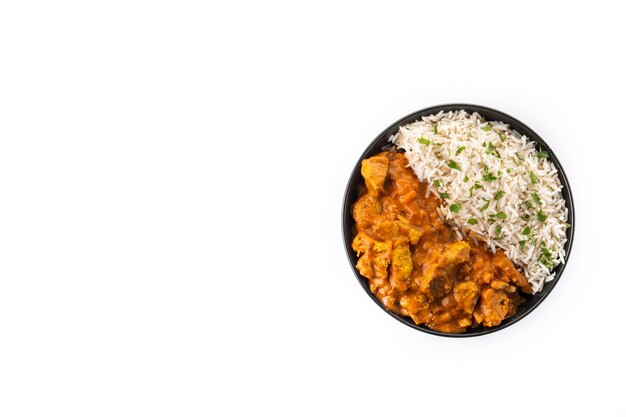 Indian butter chicken in black bowl isolated on white background