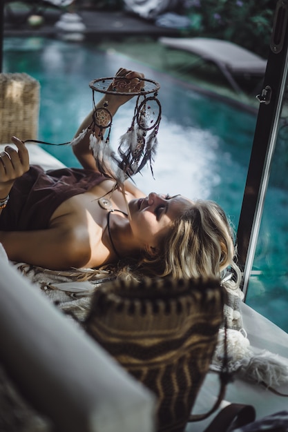 Indian girl at home. Dream catchers. beautiful blonde girl with dream catchers.