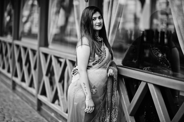 Indian hindu girl at traditional violet saree posed at street