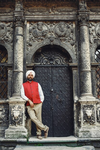 Indian man in a city. Male in a traditional turban. Hinduist in a summer city.