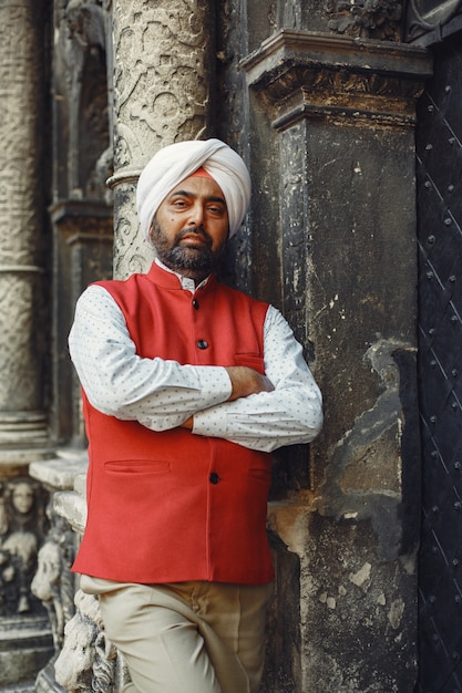 Indian man in a city. Male in a traditional turban. Hinduist in a summer city.