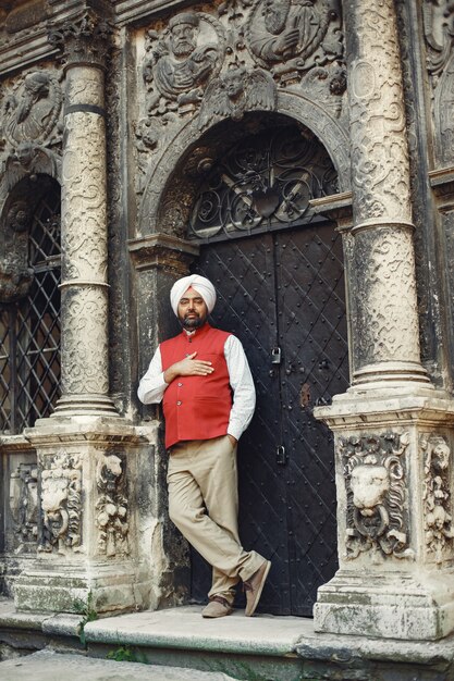 Indian man in a city. Male in a traditional turban. Hinduist in a summer city.