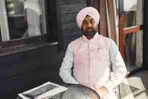 Free photo indian man in a room. male in a traditional turban. hinduist in a room.