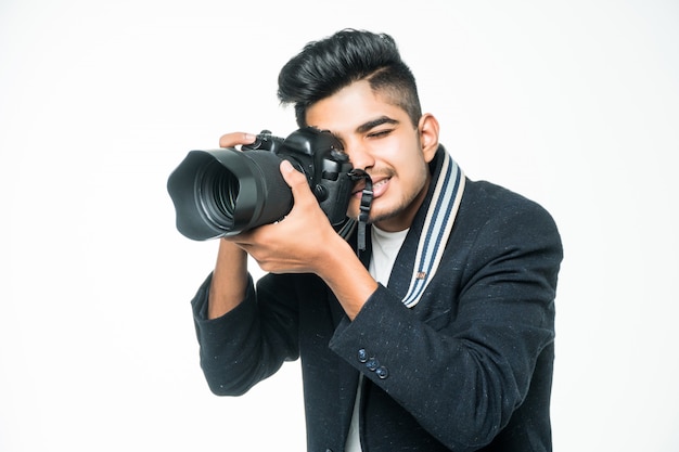 Indian photographer man holding his camera on a white background.