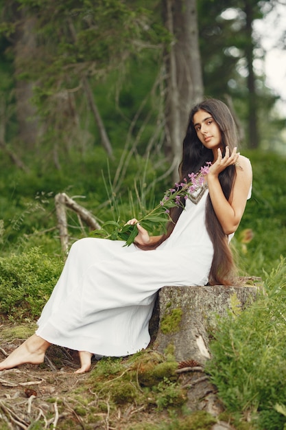 Free photo indian woman with long hair. lady in a blue dress. girl with untouched nature.