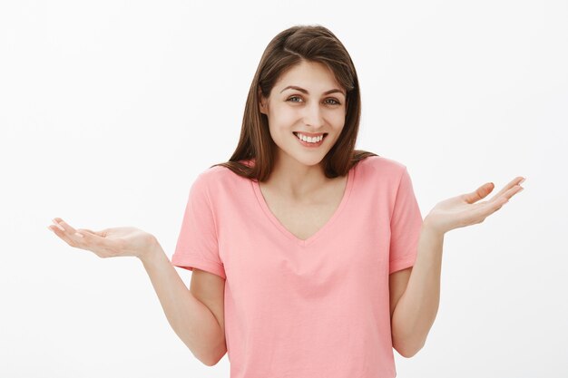 Indifferent and carefree brunette woman posing in the studio