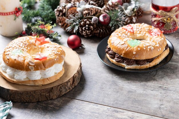 Free photo individual epiphany cake roscon de reyes with cream on wooden table