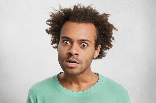 Indoor portrait of grumpy irritated annoyed man look furiosly at camera, being angry