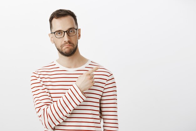 Indoor portrait of impressed good-looking guy in eyewear