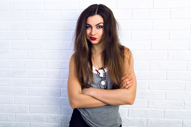 Indoor portrait of pretty cheeky young brunette woman, make displeased face, joy, fun ,emotions.