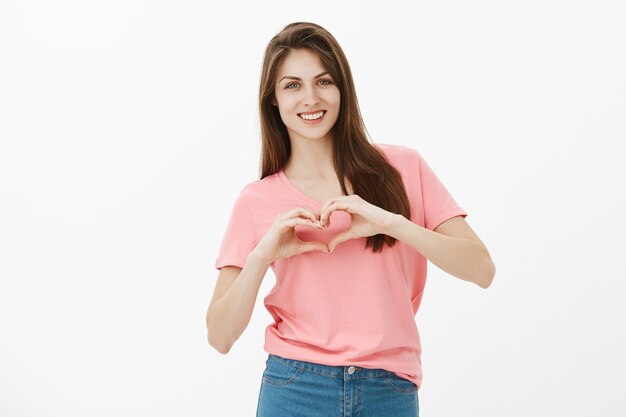 Indoor shot of charming brunette woman posing in the studio