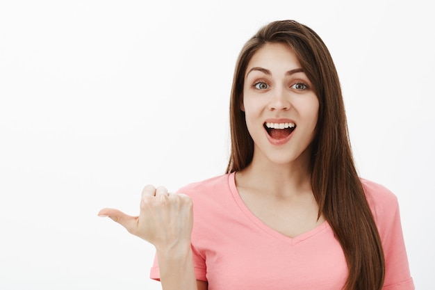 Indoor shot of excited brunette woman posing in the studio