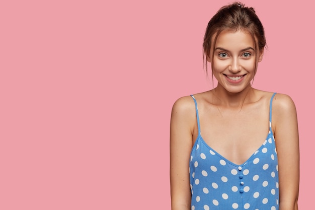 Indoor shot of happy smiling young lady with European appearance