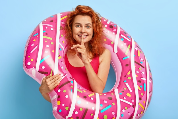 Indoor shot of pretty ginger woman with friendly look