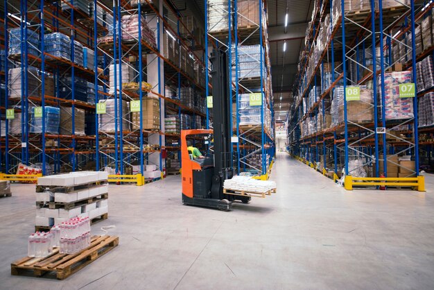 Industrial building large warehouse interior with forklift and palette with goods and shelves