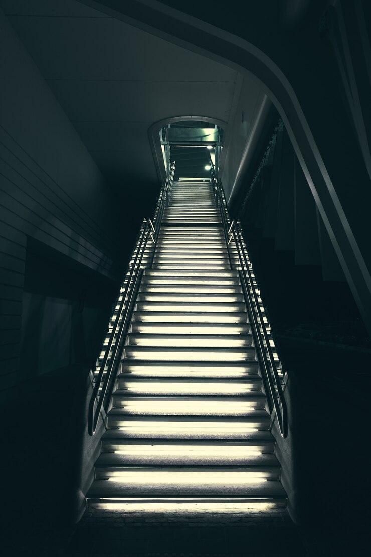 Free Photo industrial modern grey stone stairs illuminated with lights leading up