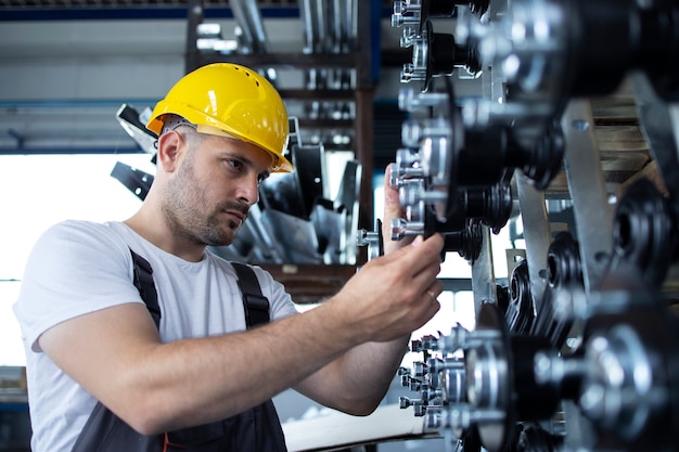 Industrial worker working at production line in factory