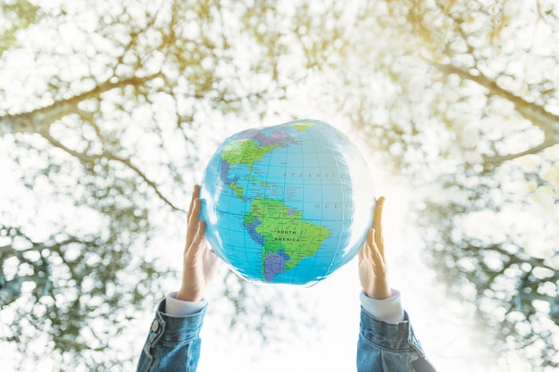 Inflatable planet model in hands in nature