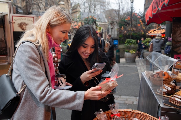 Free photo influencers taking photo of sweets at the market