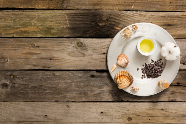 Ingredient of spa on plate over wooden desk