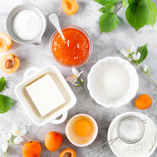 Ingredients for baking homemade apricot pie Butter sugar apricot jam Top view