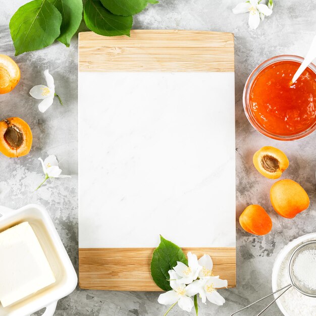 Ingredients for baking a shortbread cake with apricots Butter sugar eggs apricot jam Top view Square Space for text